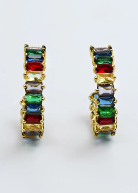 Pair of gold earrings with colorful gemstones on a white background
