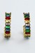 Pair of gold earrings with colorful gemstones on a white background